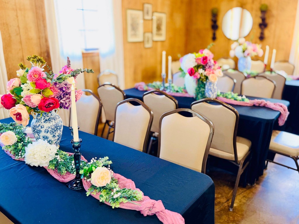 Long table setting with pink table runner and floral centerpieces