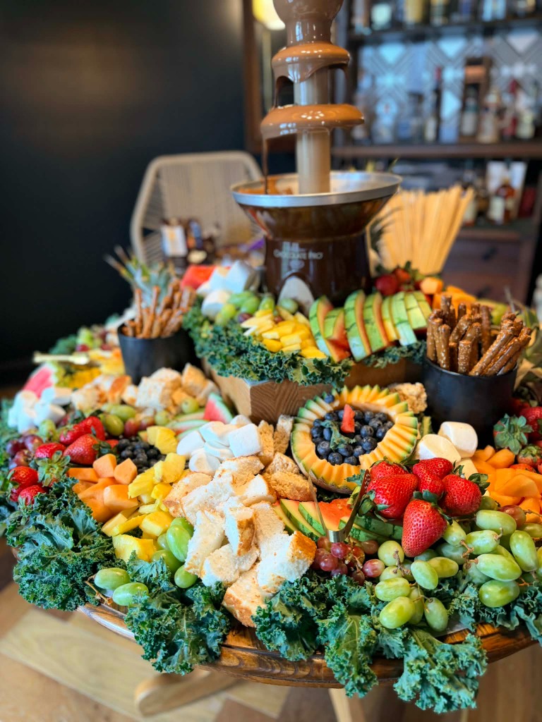 Chocolate fountain with fresh fruit and treats catering display