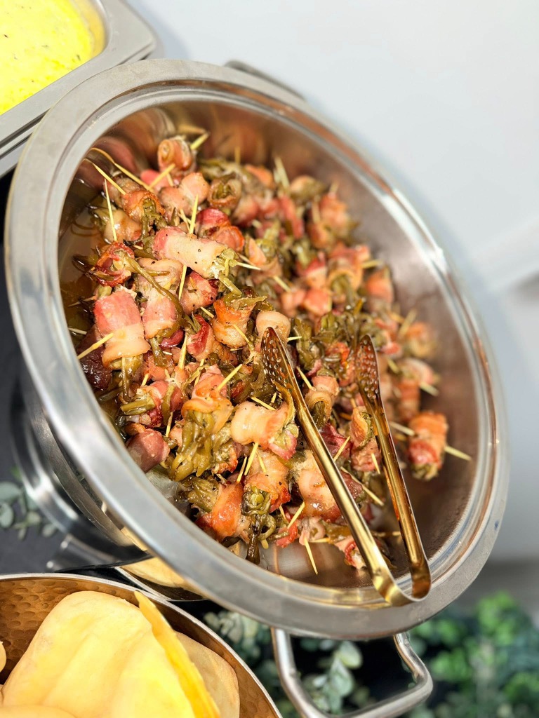 Bacon wrapped green beans in a chafing dish