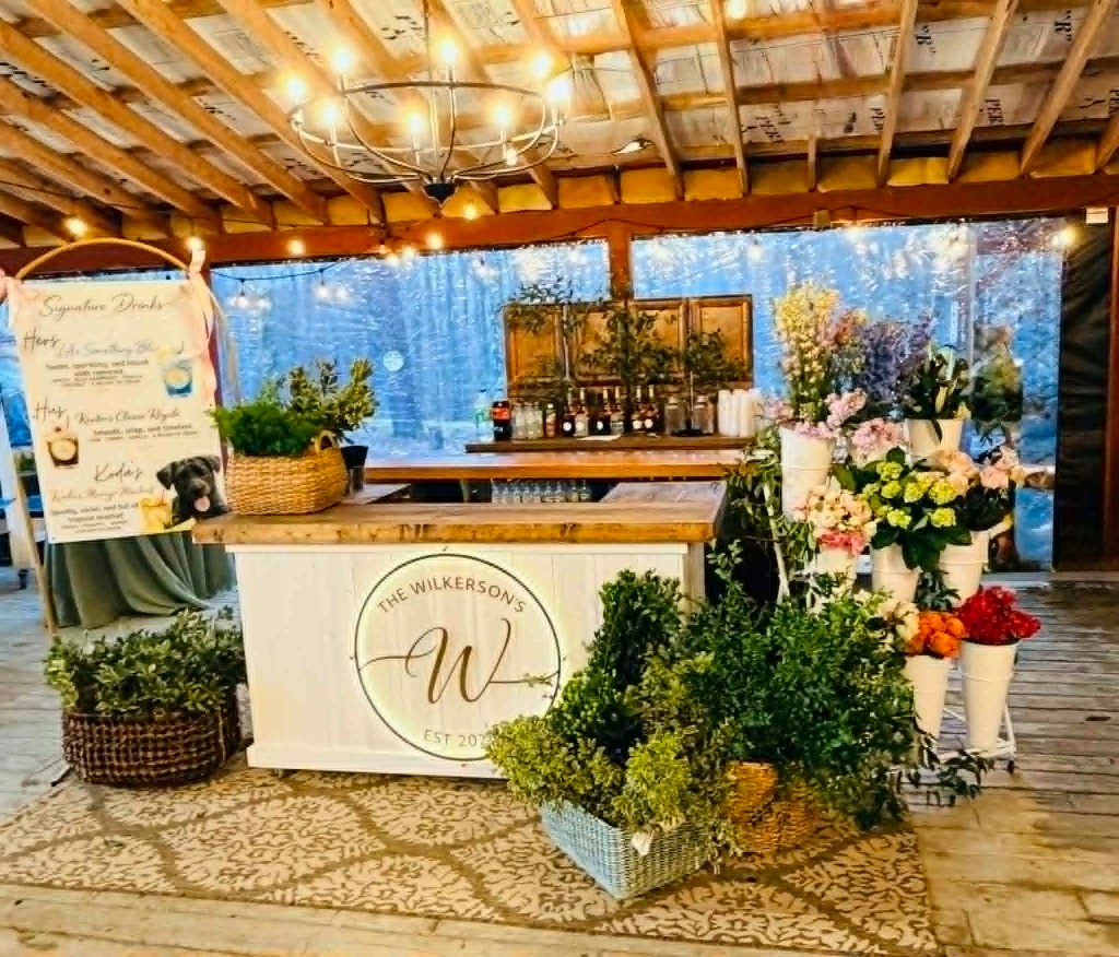 A beautifully decorated mobile beverage cart set up for an event