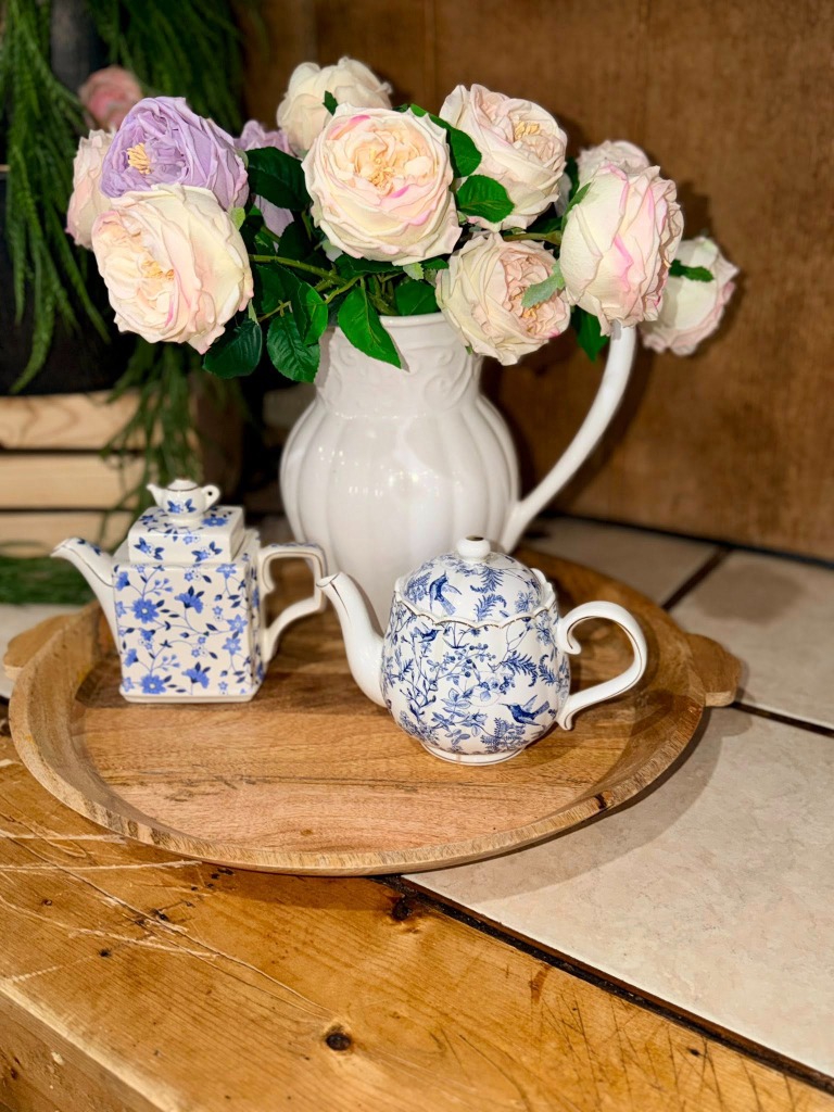Blue and white teapots with pink and purple roses