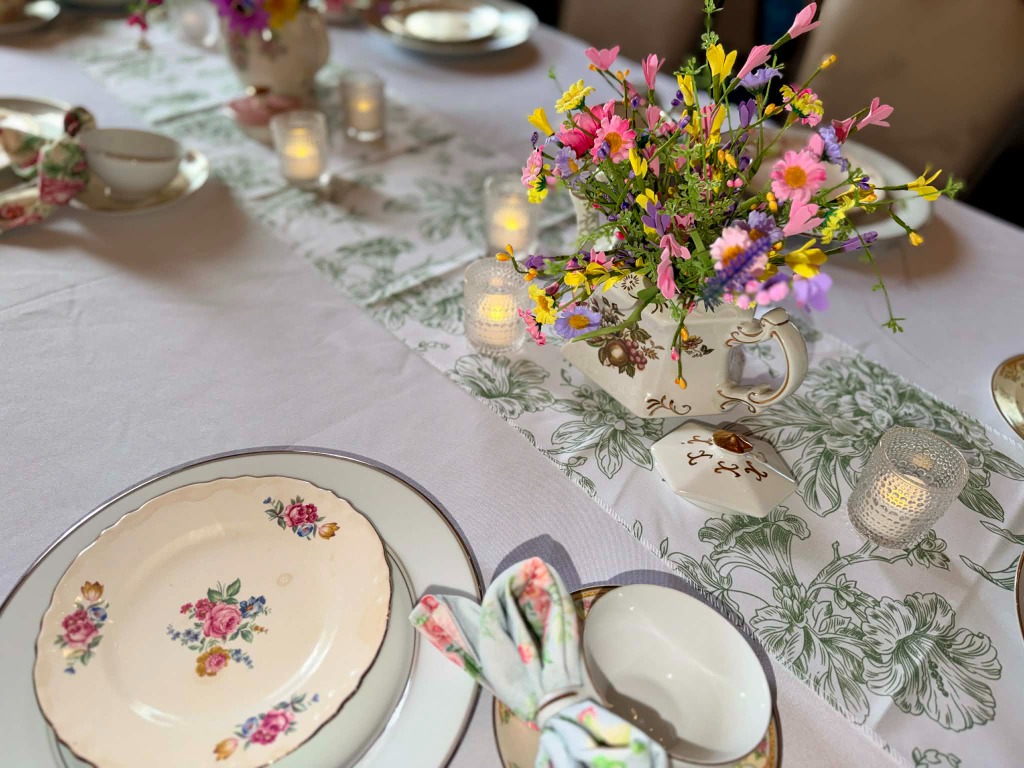 Wedding shower game station with pearl necklaces and floral signage