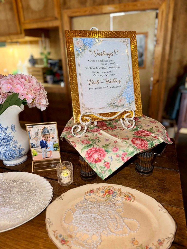 Intimate table setting with floral runner, votives, and vintage china