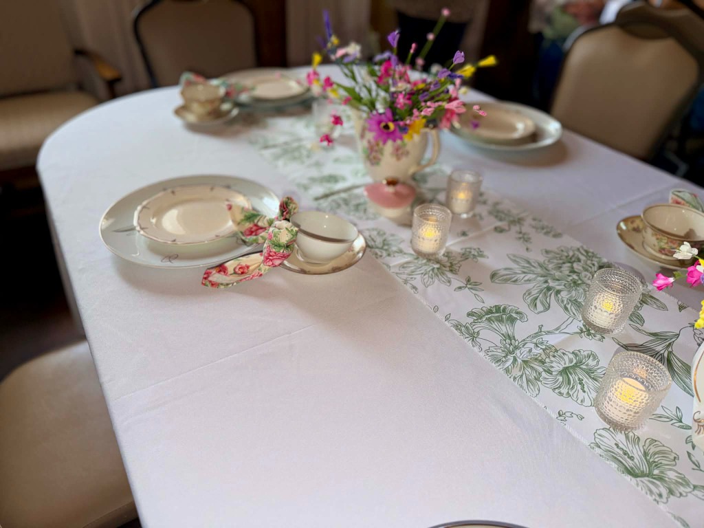 Table with botanical runner, wildflowers, and candlelight votives