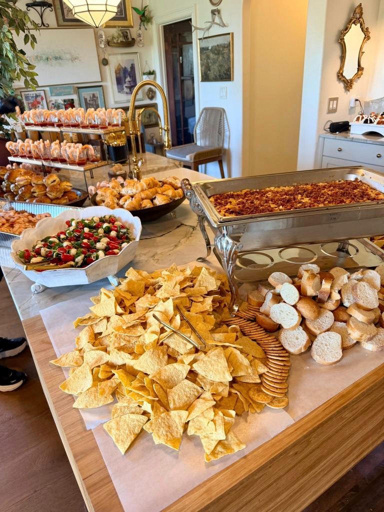 Kitchen island spread with a chafing dish, bread, and chips