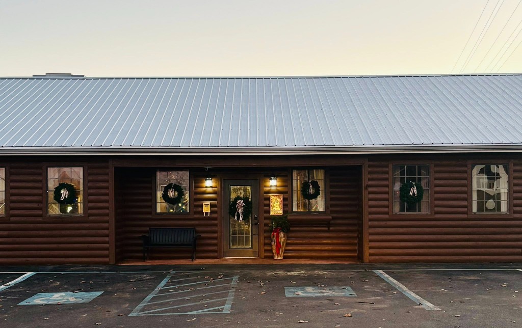 The Gathering Porch venue exterior at dusk with wreaths on the windows