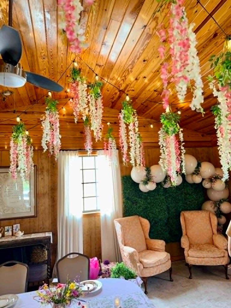 The Gathering Porch venue interior with hanging floral decorations and elegant seating
